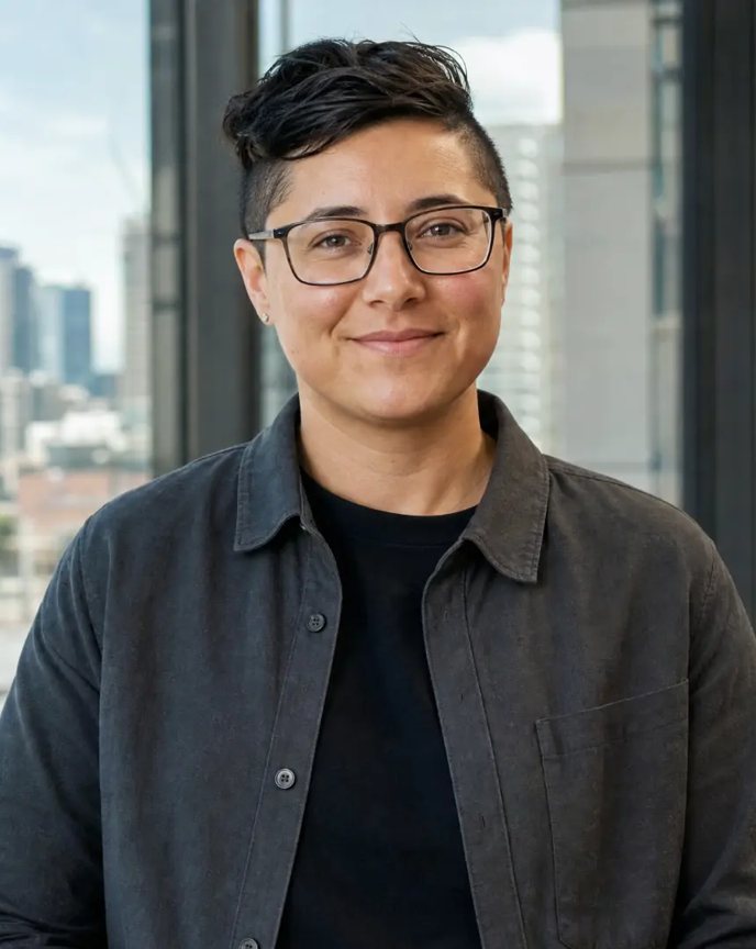 Photo of Alex from People and Culture, with short dark hair and glasses, in an office overlooking a site.